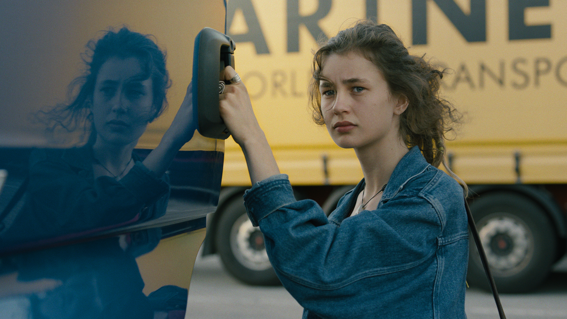 Young Woman holding the door of a truck