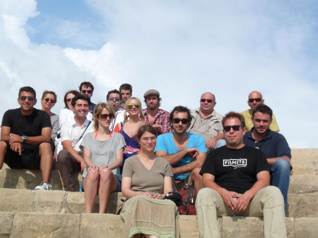 group of people sitting on outside stairs
