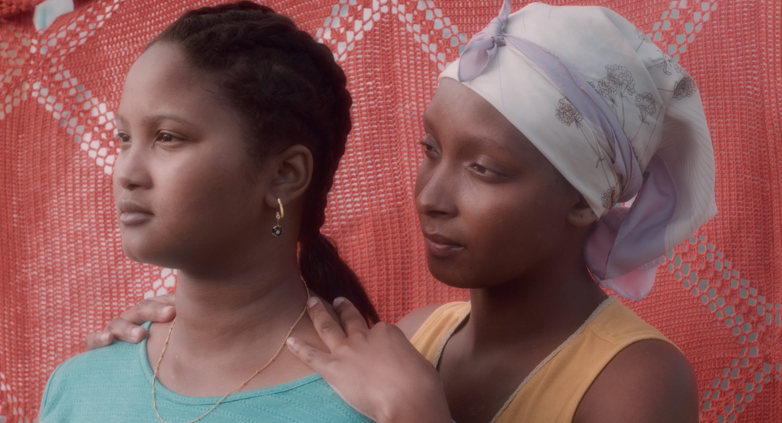 Woman holding a younger woman's shoulders from behind