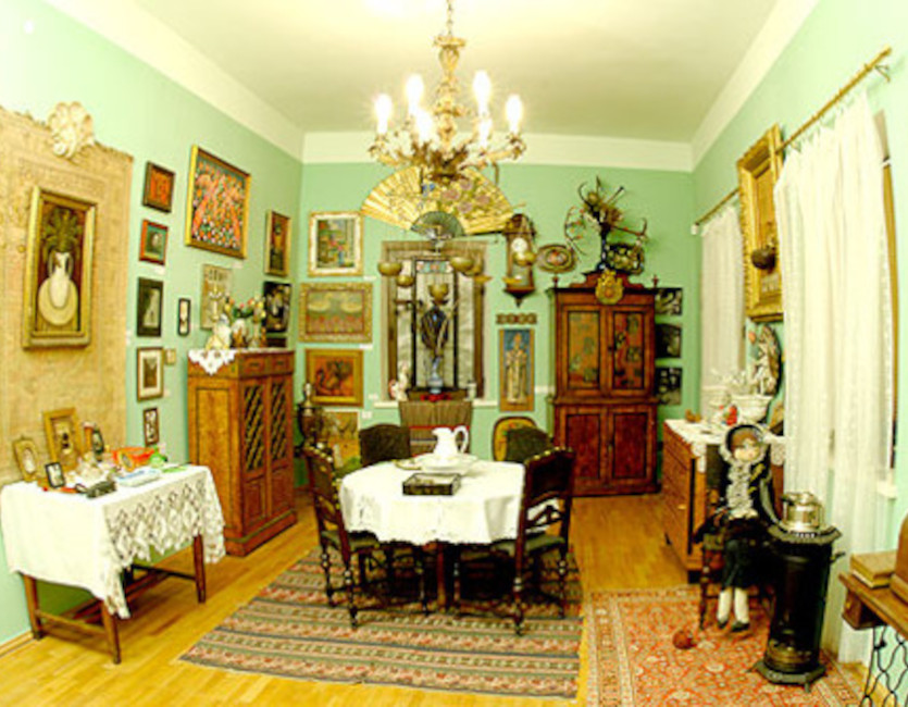 Photo of a fully decorated room with many pictures on the walls