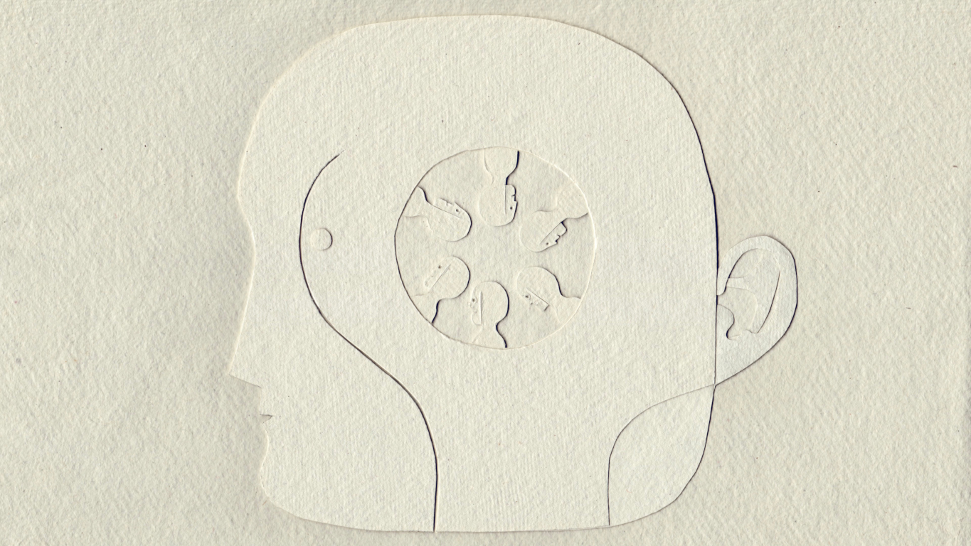 cut-out image of a circle of heads inside a bigger head