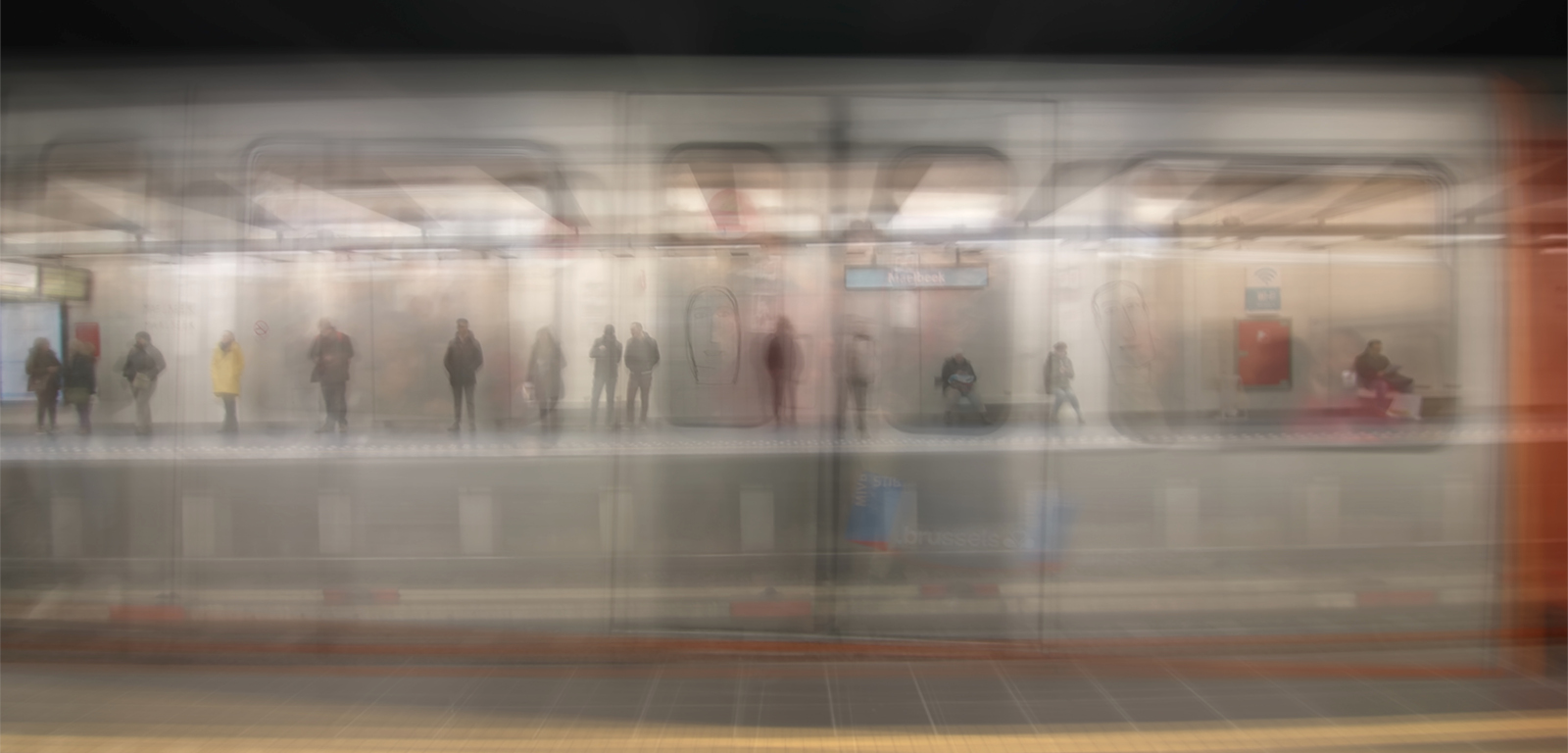 blurry image of people standing on an underground platform