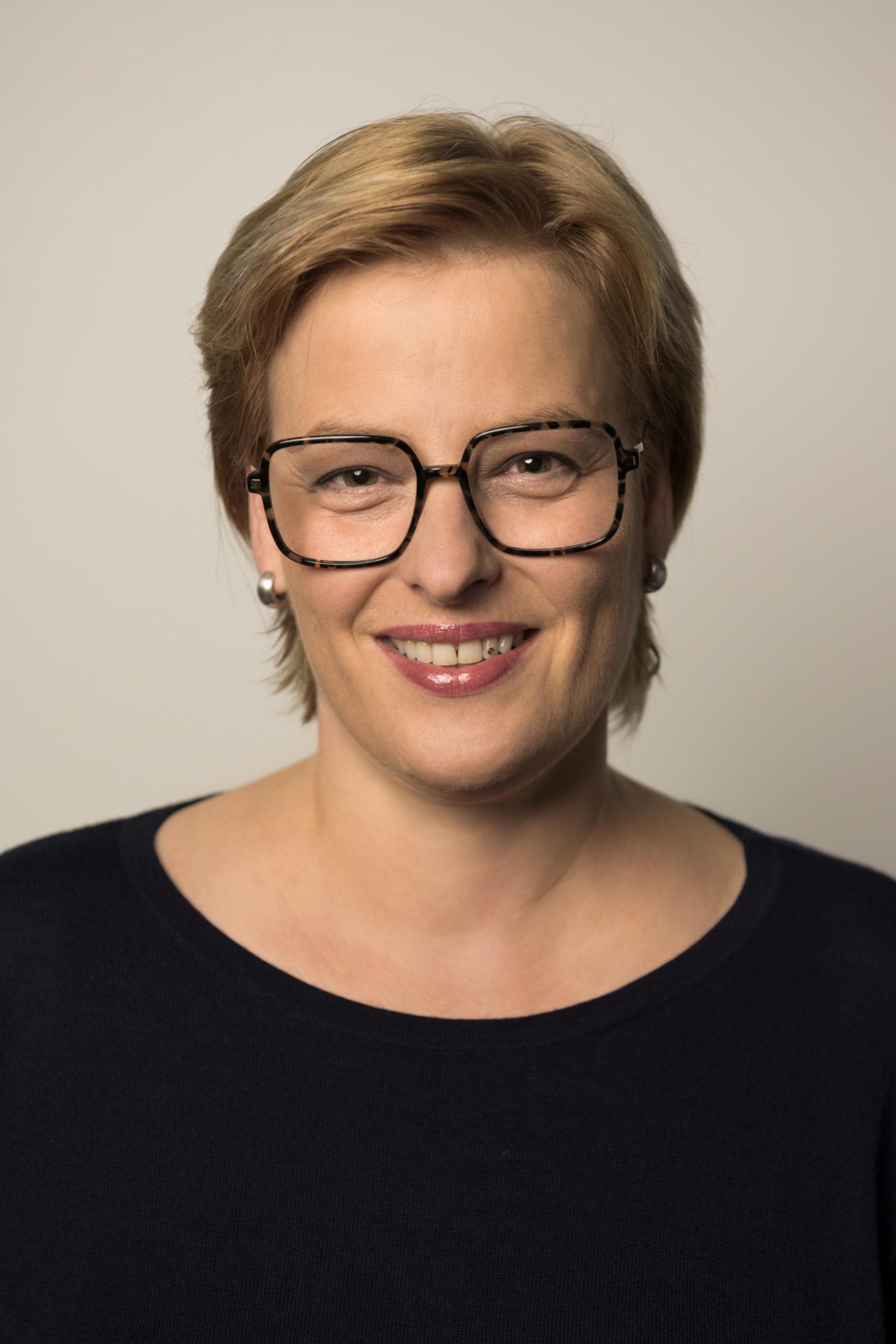 portrait of a short-haired woman with glasses