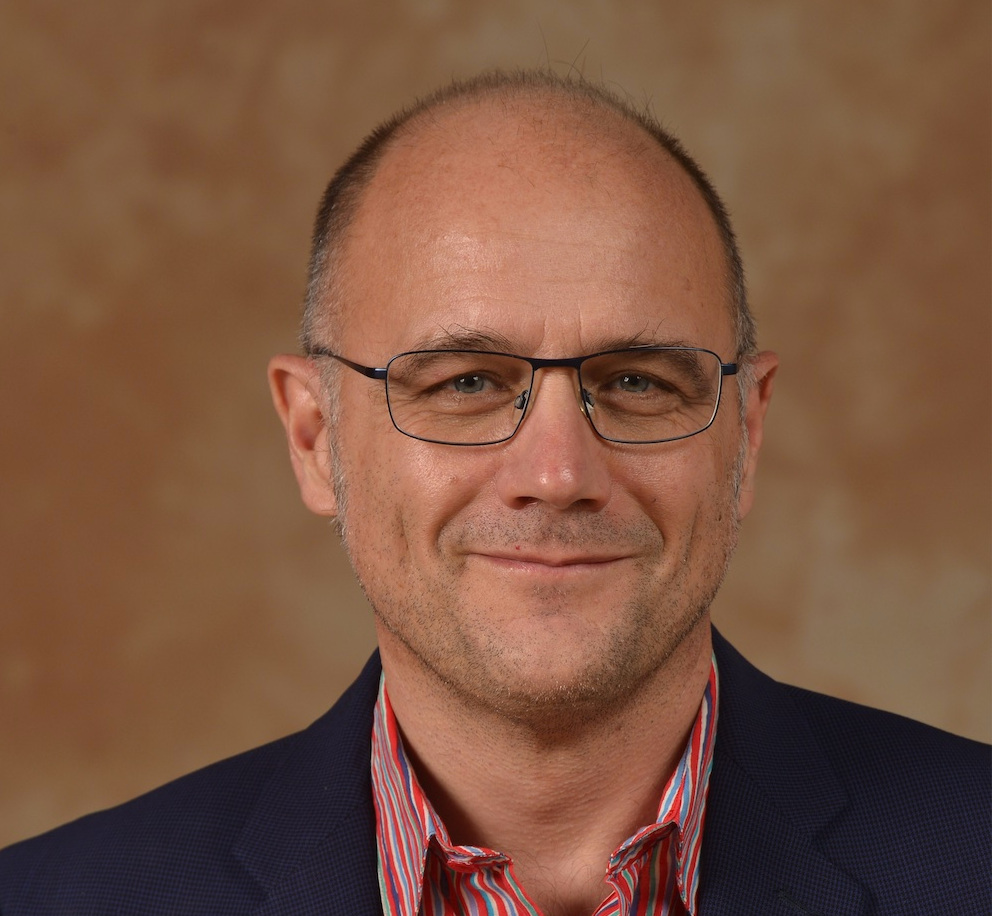 portrait of a man with metal-framed glasses