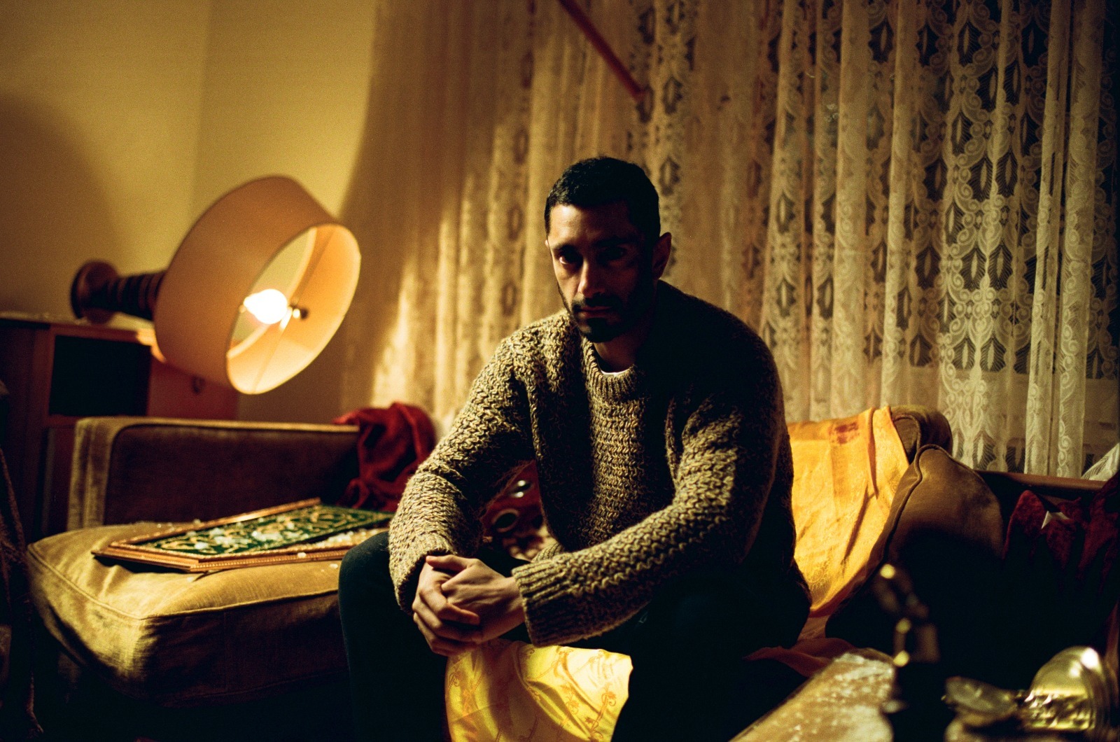 still of man sitting on sofa at night