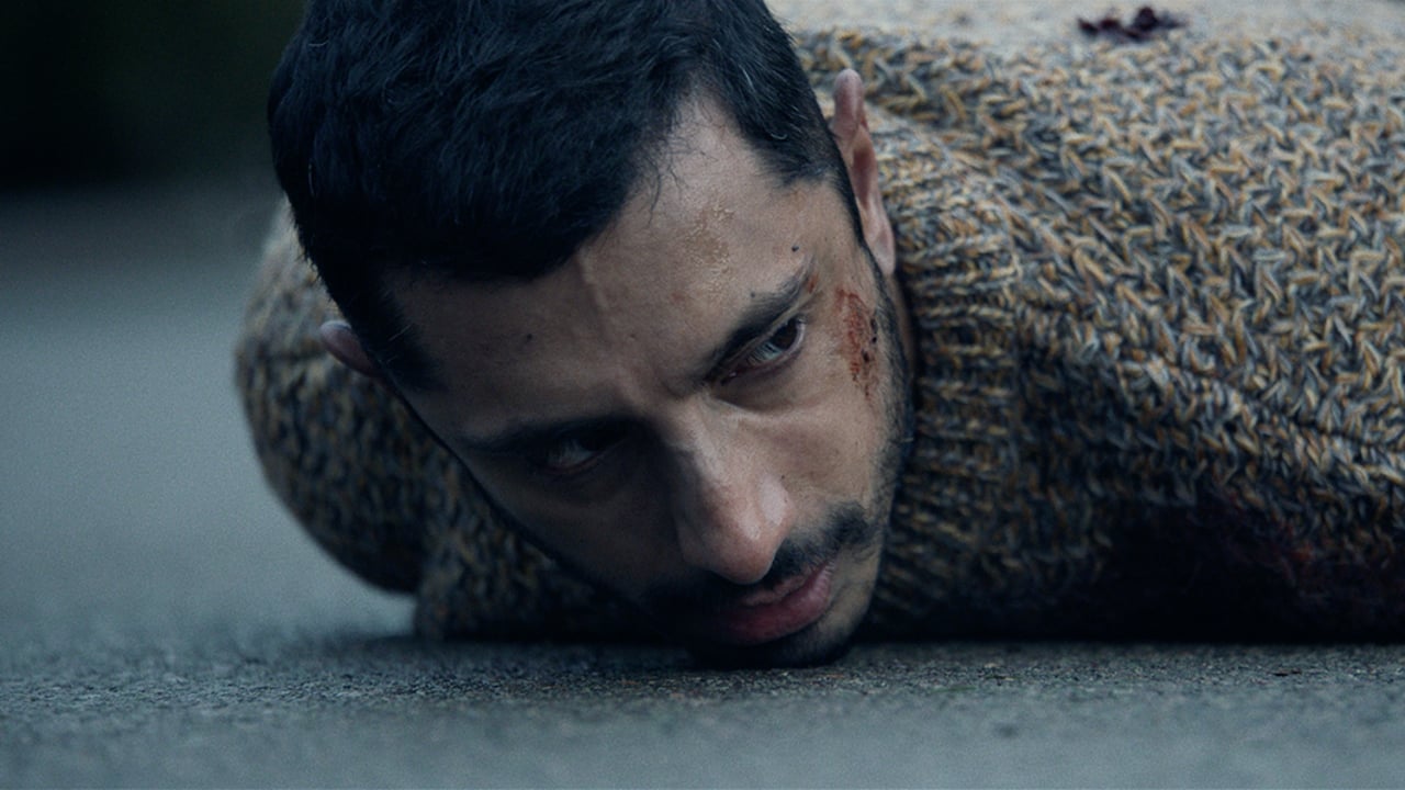 still of wounded man lying on concrete