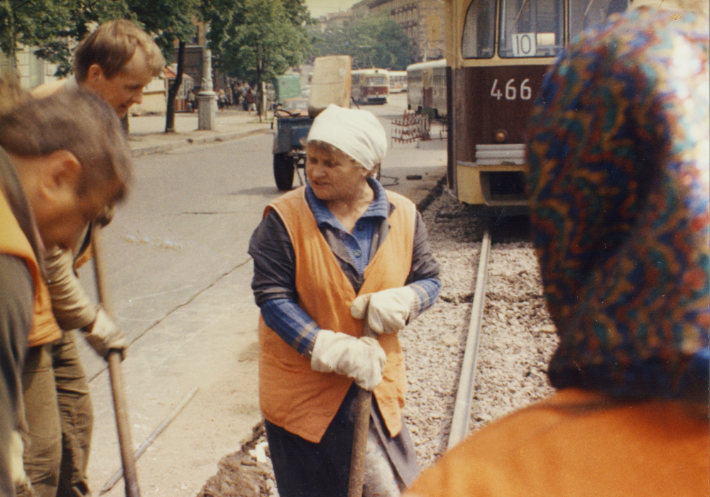 Film still of street workers wearing orange vests