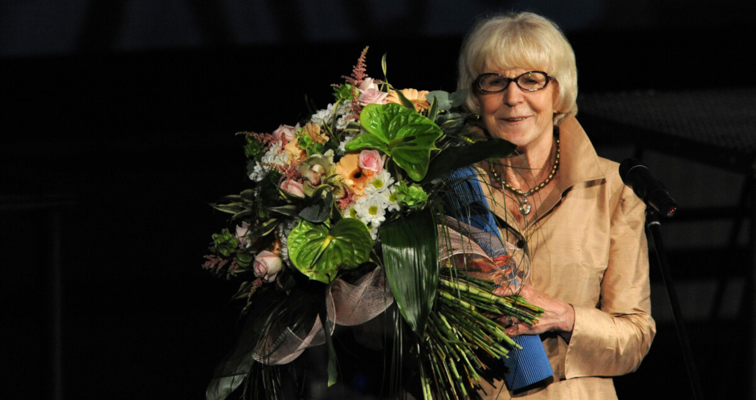 photo of bespectacled lady with flowers