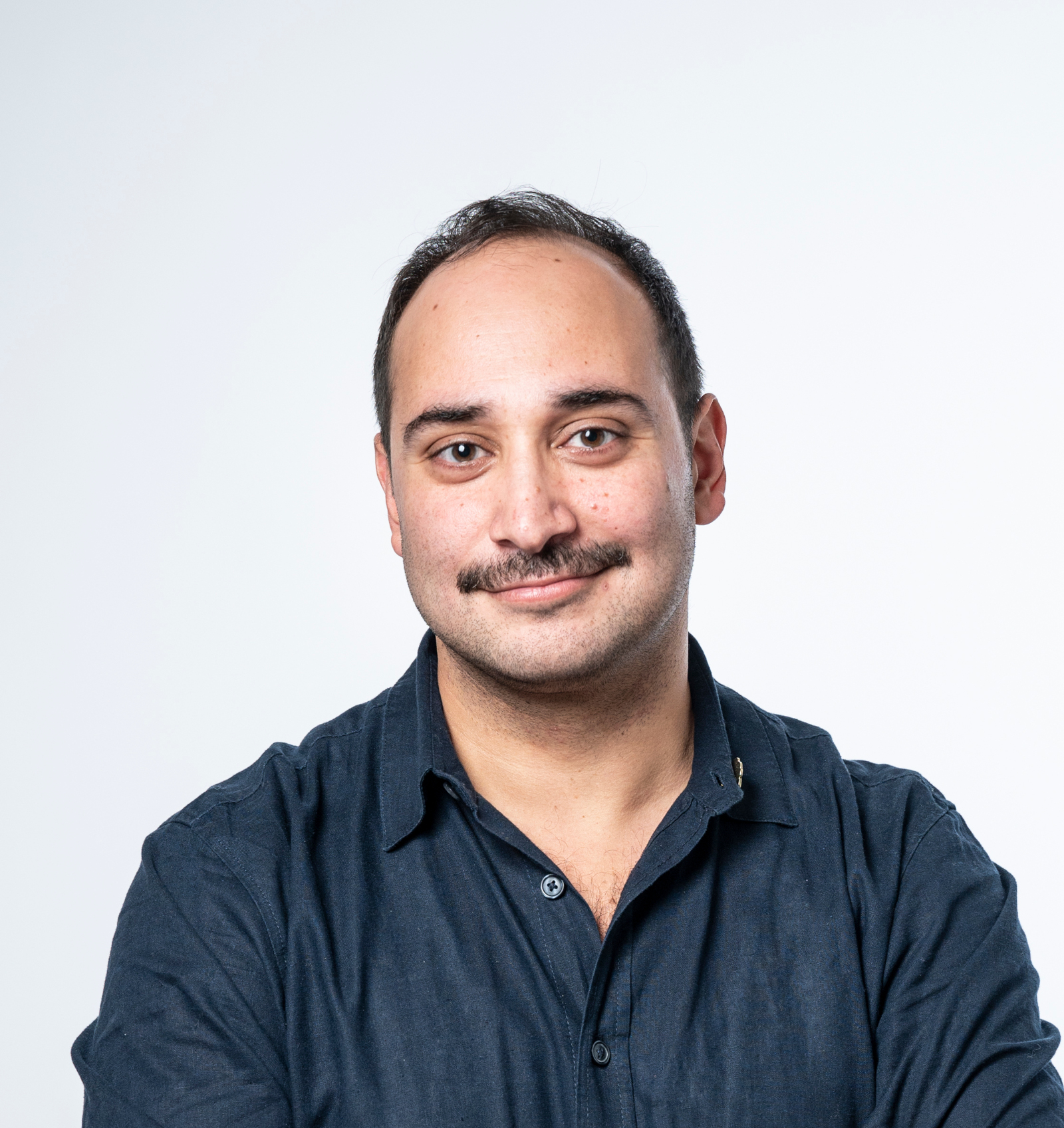 colour portrait of a person in a dark shirt with mustache