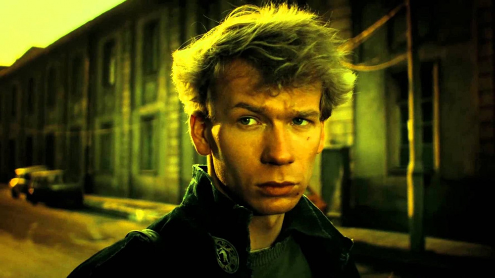 Film still: Troubled man on the street, light from behind