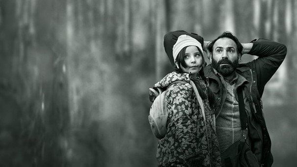 Film still: Troubled man and child in the forest